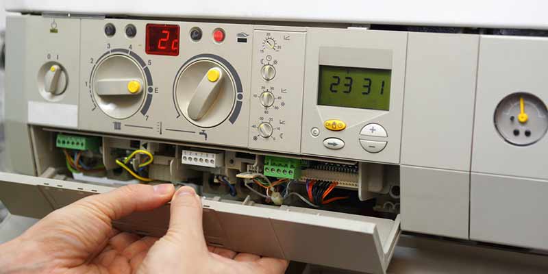 Heating system control panel with visible dials and digital display, illustrating maintenance and repair services by Mid Florida A/C in DeBary, Florida.