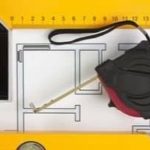 Tape measure on a blueprint, illustrating HVAC measurements for proper system sizing.