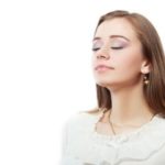 Woman enjoying fresh air, promoting healthy indoor air quality, relevant to HVAC services and maintenance tips.