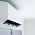 Ductless mini-split air conditioning unit mounted on a wall, illustrating energy-efficient climate control for individual zones in homes.